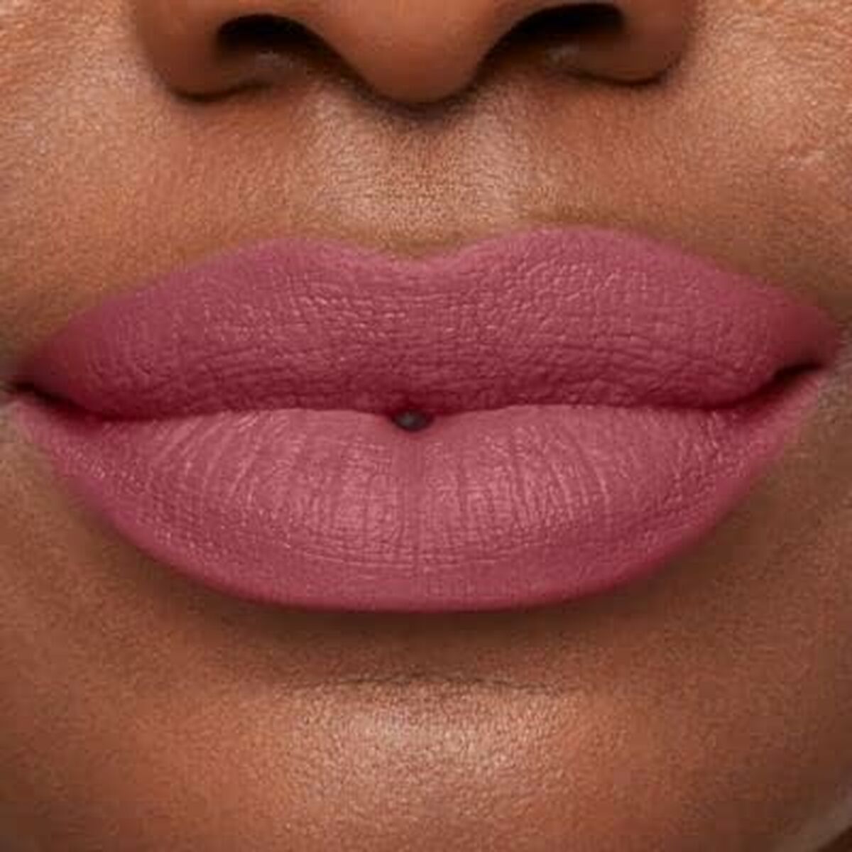 Lips showcased in Charming Pink shade of bareMinerals Mineralist lipstick, emphasizing a smooth matte finish.