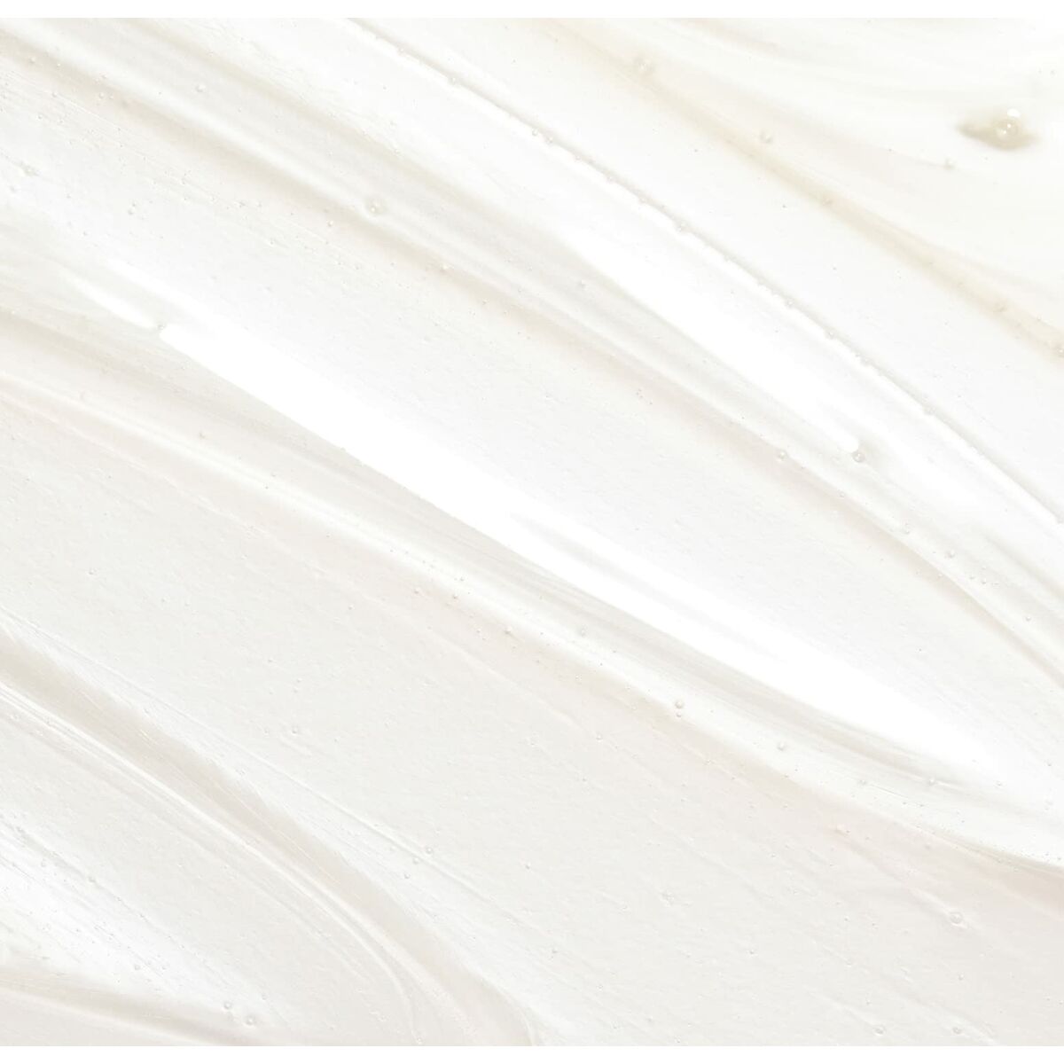 Textured white cream resembling the consistency of skincare or haircare product for enhancing beauty.