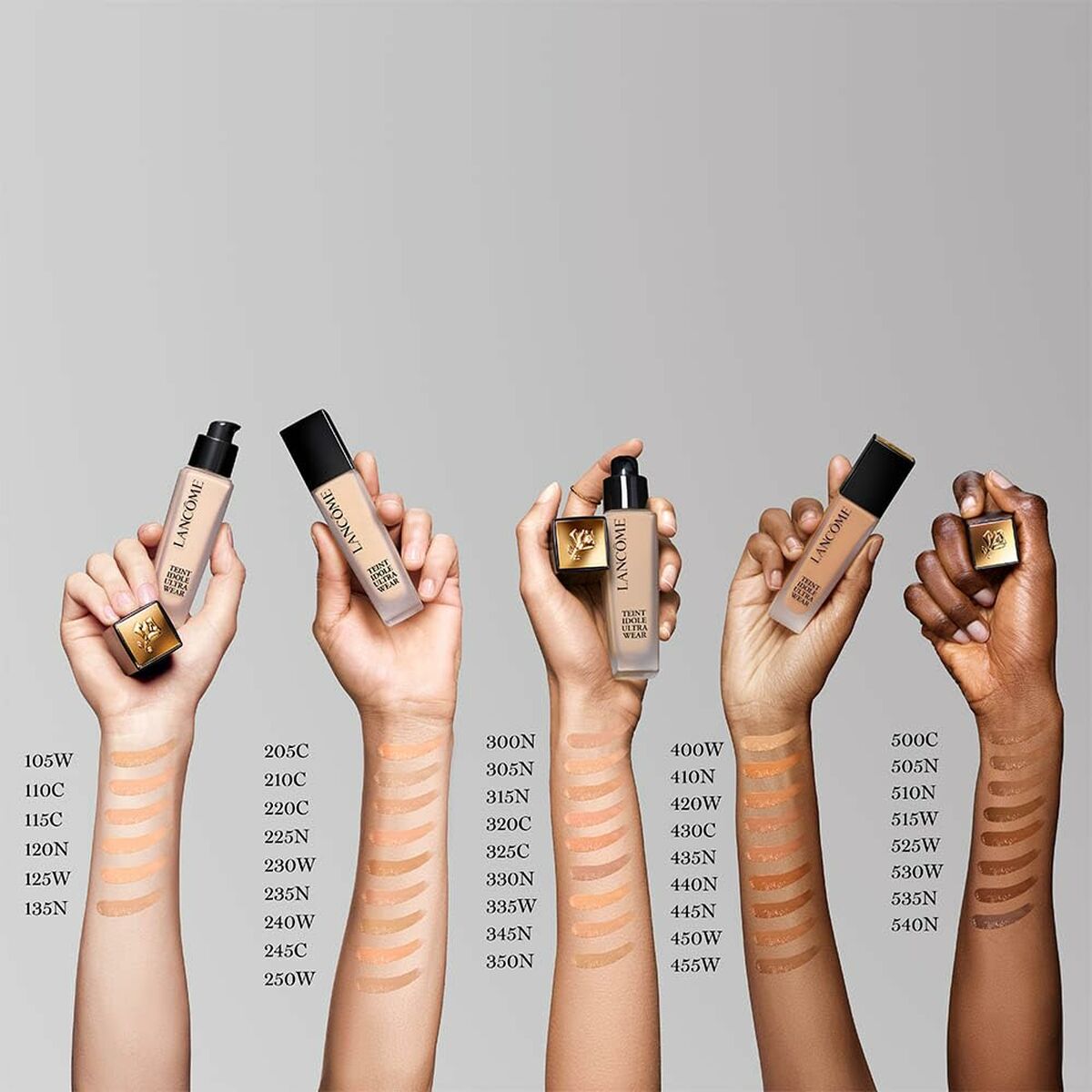 Lancôme Teint Idole Ultra Wear foundation shades displayed on hands with swatches, showcasing a range of skin tones.