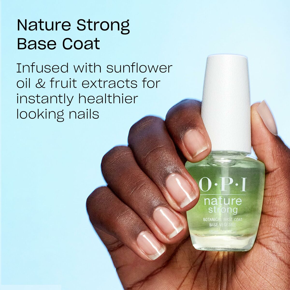 OPI Nature Strong Base Coat bottle with hand, promoting healthier nails with sunflower oil and fruit extracts.