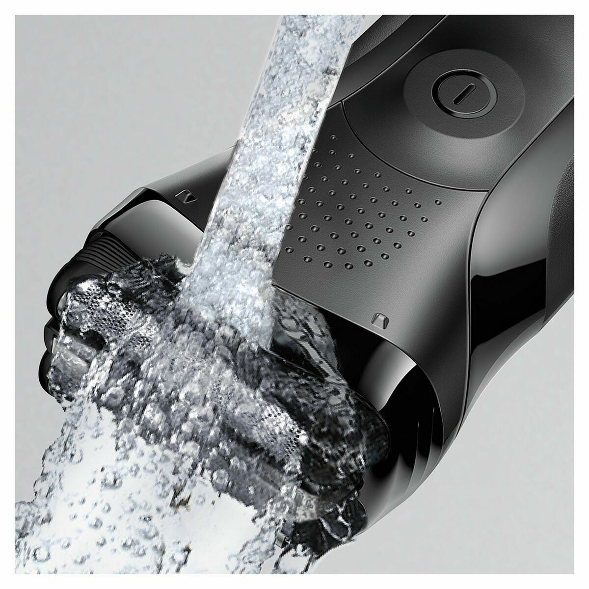 Braun BT3000 trimmer with water running over it, showcasing its waterproof design and quality.