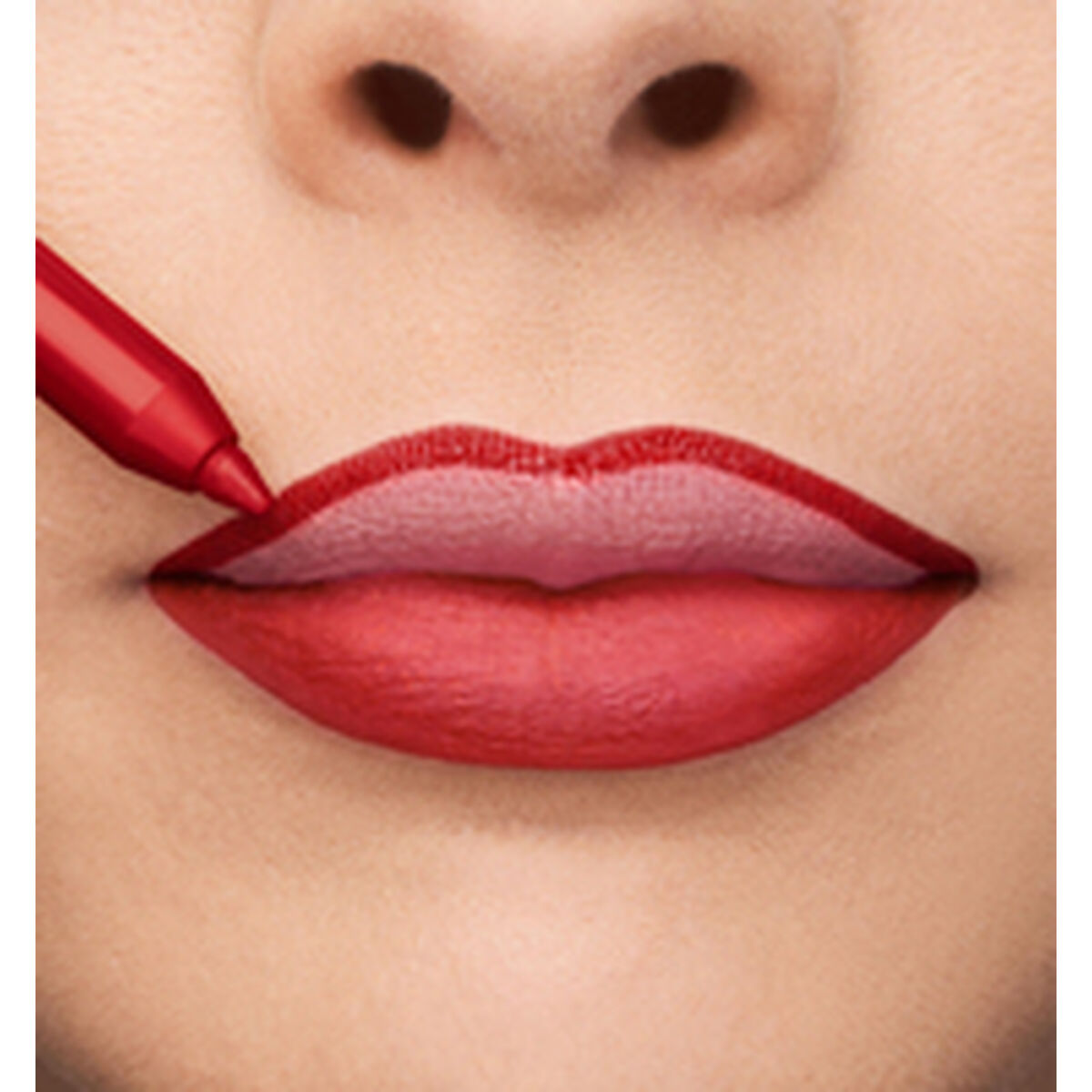 Applying red lipstick with precision for a bold and attractive lip look.
