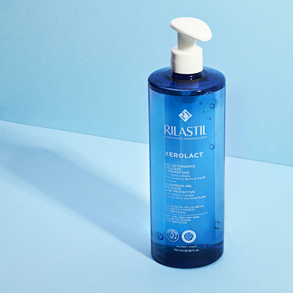 Rilastil XEROLACT cleansing gel 750 ml in a blue bottle on a blue background, ideal for skincare.